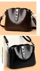 Detail of dark brown and black bucket bags with polished leather and silver hardware