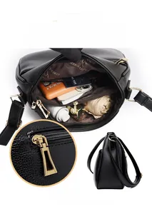 Internal view of black textured leather crossbody bag with multiple storage compartments