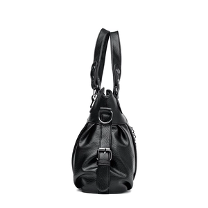 Black pebbled leather tote bag for women featuring silver rivets and adjustable side straps