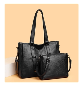 Détails du sac cabas noir 2 pièces montrant la texture grainée et la bandoulière réglable