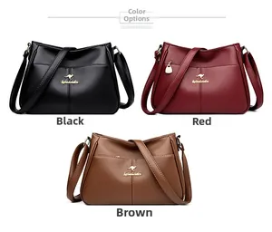 Close-up of textured leather handbags in black, red, and brown with golden kangaroo logos