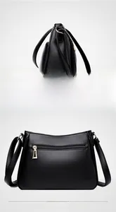 Close-up of black litchi grain leather bag showing the side view and rear zipper pocket