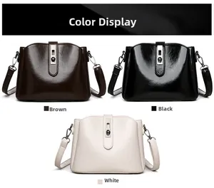 Detailed view of three glossy crossbody bags with decorative floral metal clasps