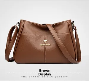 Close-up of brown pebbled leather texture and gold kangaroo emblem on crossbody bag