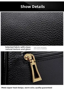 Close-up of black lychee grain leather texture and premium gold metal zipper details