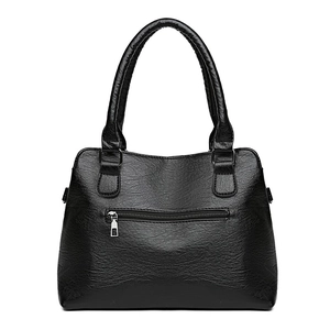 Classic black faux leather tote bag with silver zipper pocket and reinforced handles