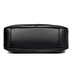 Bottom view of black pebble leather shoulder bag with reinforced stitching details