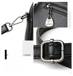 Detailed macro view of litchi texture black leather strap and metallic zipper hardware