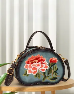 Close-up of elegant peony floral embroidery on a vintage style crossbody hand bag