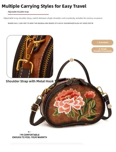 Detailed close-up of brown vintage leather handbag with floral embroidery and gold hooks