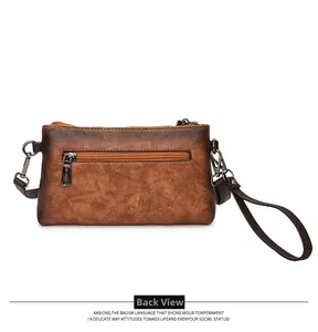 Rear view of vintage brown leather envelope bag with functional zipper pocket and wristlet