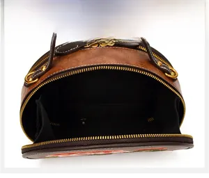 Top view of brown crossbody bag showing internal compartments and gold zipper detail