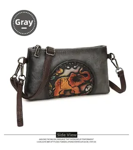 Detail view of the embossed colorful elephant pattern on the grey retro envelope bag