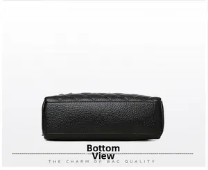 Detailed bottom view of black pebble grain leather bag with reinforced stitching
