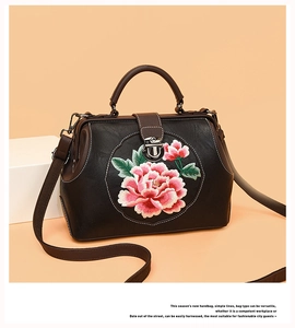 Detail of pink peony embroidery on black PU leather handbag with vintage metal clasp
