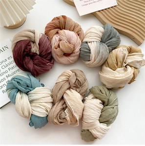 Detailed close-up of pleated cotton linen scarves in various Morandi color tones