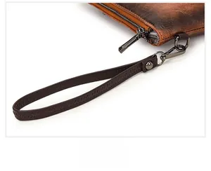 Detailed macro view of vintage brown leather bag featuring durable metal zipper and D-ring