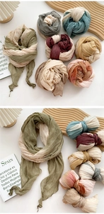 Close-up of lightweight pleated tie-dye linen scarf with elegant textured fabric details