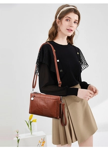 Brown crocodile embossed leather crossbody bag shown on a model for daily styling