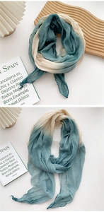 Detail of gradient cotton linen scarf with soft crinkle texture and beige blue tones