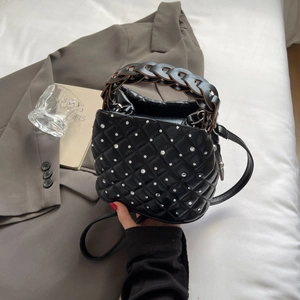 Quilted black bucket bag with sparkling rhinestones and woven top handle