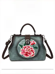 Close-up of pink peony floral embroidery on a vintage blue Chinese style handbag