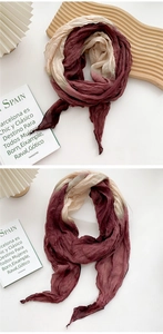 Detail of tie-dye cotton linen scarf showing burgundy beige texture and pleated fabric