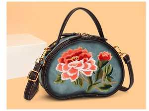 Detailed embroidery of peony flowers on vintage blue bean-shaped crossbody handbag