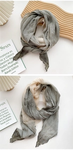 Detail of olive green and beige pleated cotton linen scarf with natural texture
