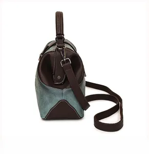 Side view of vintage green Boston bag featuring contrast stitching and leather texture