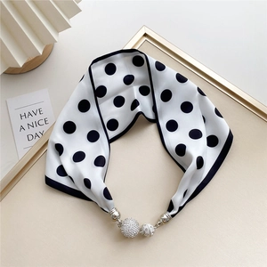 Detailed view of polka dot silk scarf necklace with sparkling rhinestone magnetic buckle