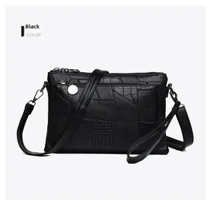 Detail of black PU leather crossbody bag featuring mixed crocodile and snake textures