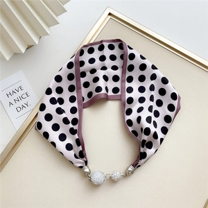 Detail of light pink polka dot silk scarf necklace with sparkling rhinestone magnetic balls