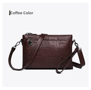 Detail of coffee brown PU leather bag with crocodile texture and detachable shoulder strap