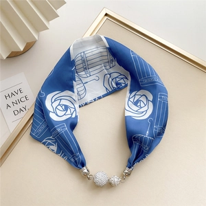 Detail of silk scarf with blue roses, birdcage print and crystal magnetic clasp
