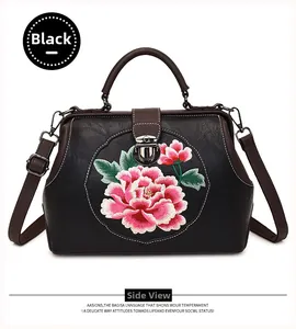 Detail of black doctor bag with peony embroidery and textured lychee pattern leather