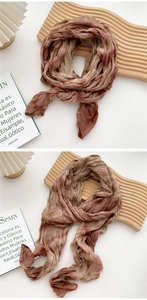 Detail of hand-dyed cotton linen scarf showing natural gradient and pleated texture