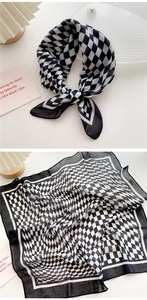 Detail of a black and white checkered cotton linen scarf tied in a bow with flat layout