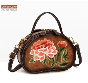 Close-up of coffee brown saddle bag with intricate Chinese peony floral embroidery