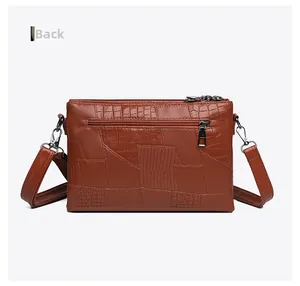 Detailed back view of brown PU leather envelope bag with crocodile embossed texture