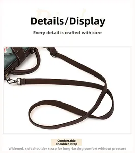 Detail of wide fabric shoulder strap with retro brass buckle on green floral handbag