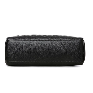 Bottom view of textured black pebbled leather square bag with quilted stitching details