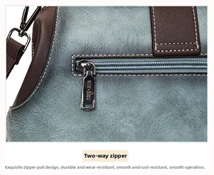 Detail of durable two-way silver zipper on textured faux leather handbag with fine stitching