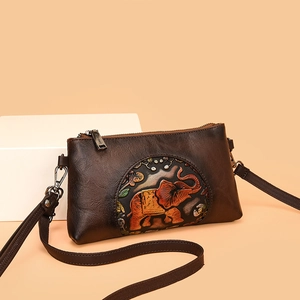 Vintage brown leather crossbody bag with embossed elephant and floral patterns
