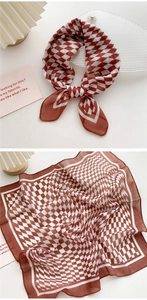 Detail of red and white checkered square scarf with delicate stitching and sheer fabric