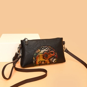 Vintage black leather envelope bag with a colorful embossed elephant and long strap