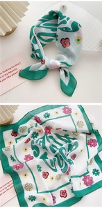 Detail of a green and white floral cotton-linen scarf with elegant tied styling