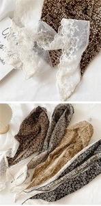 Close-up of floral print cotton scarf with delicate white embroidered lace borders