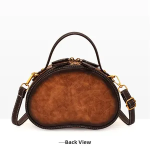 Back view of vintage paisley round crossbody bag in brown gradient leather texture