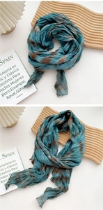 Macro detail of sky blue tie-dye cotton linen scarf with natural crinkle texture